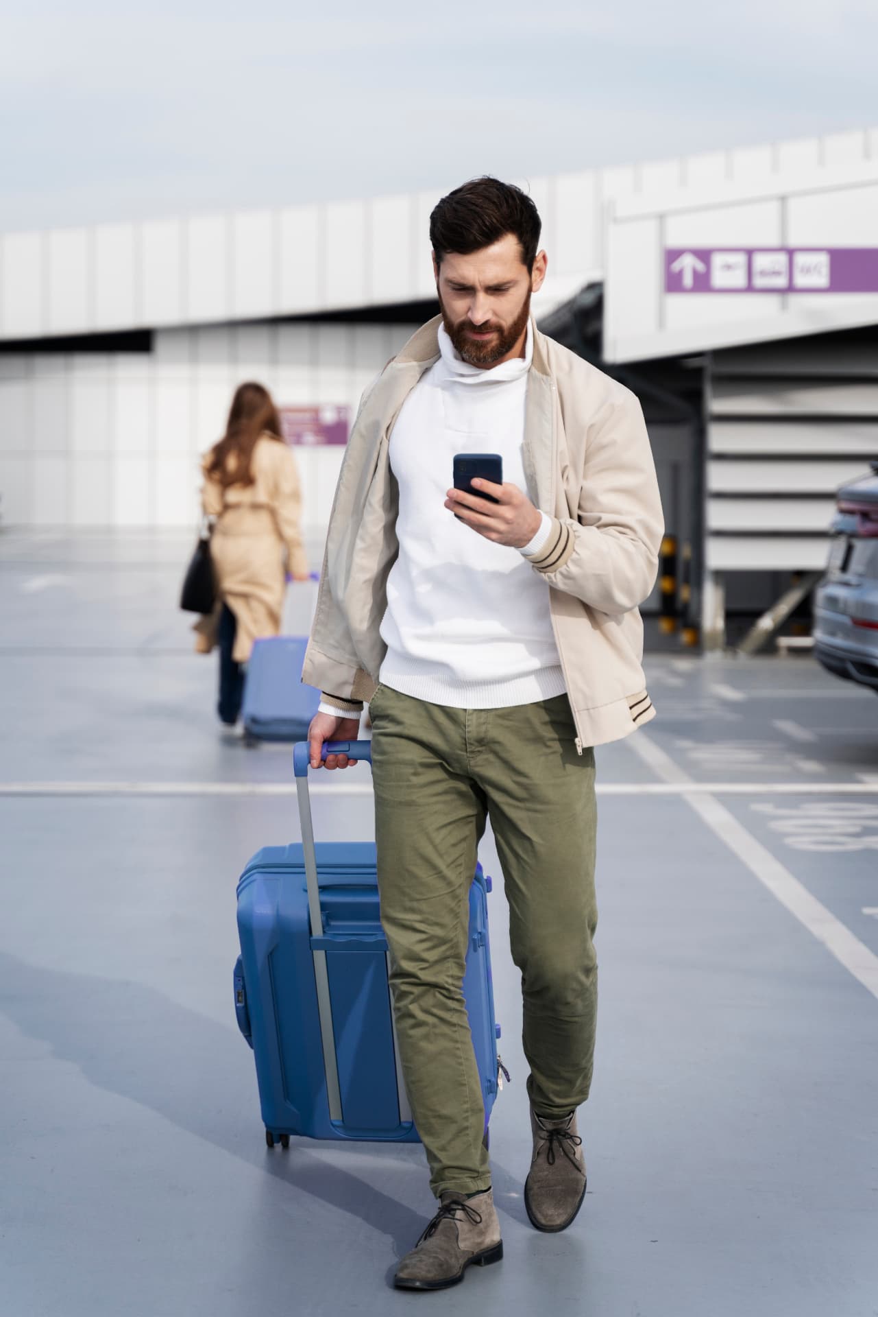 A traveller checking SafariScan on his phone at the airport