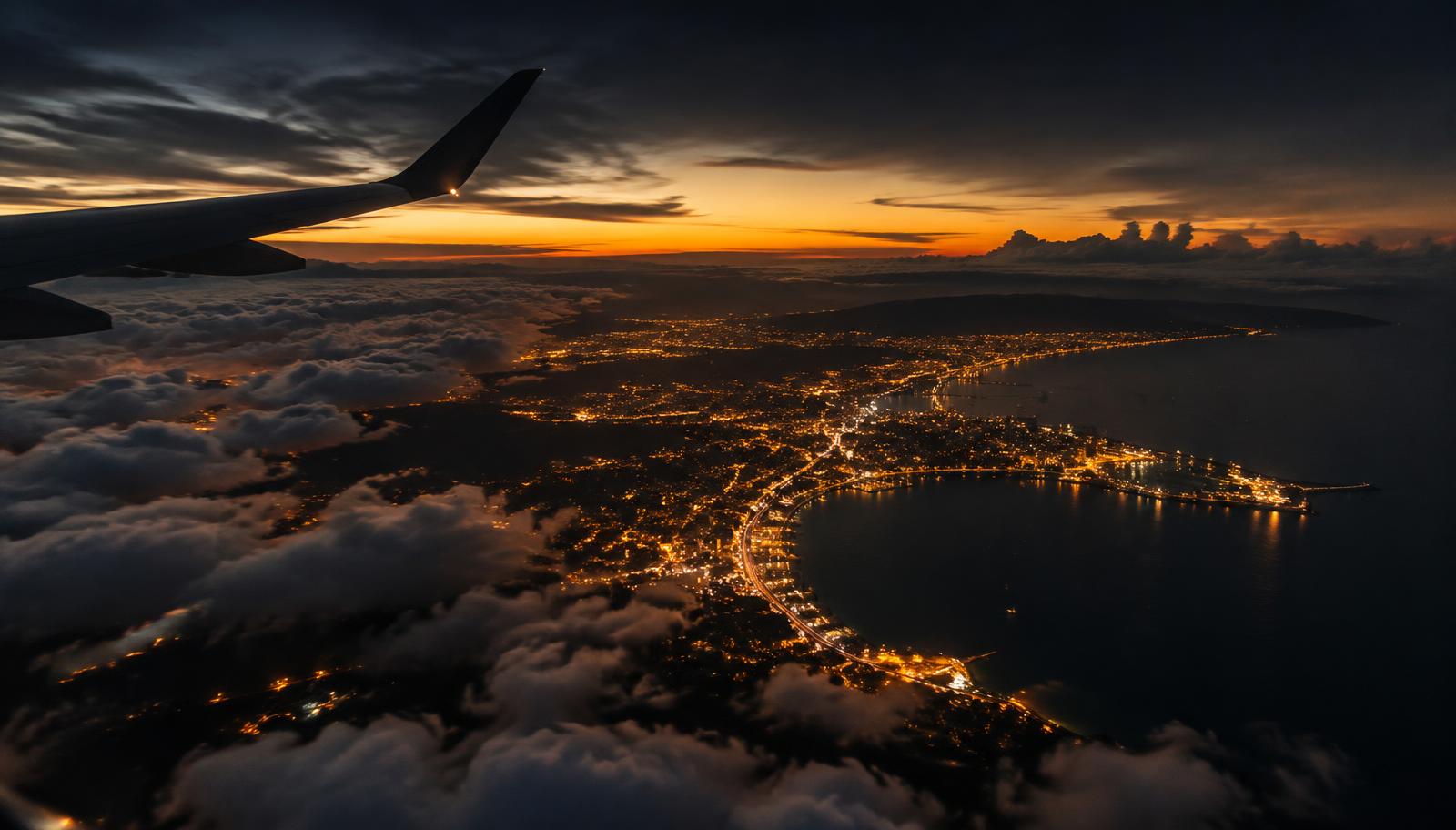 City lights seen from an airplane window at dusk